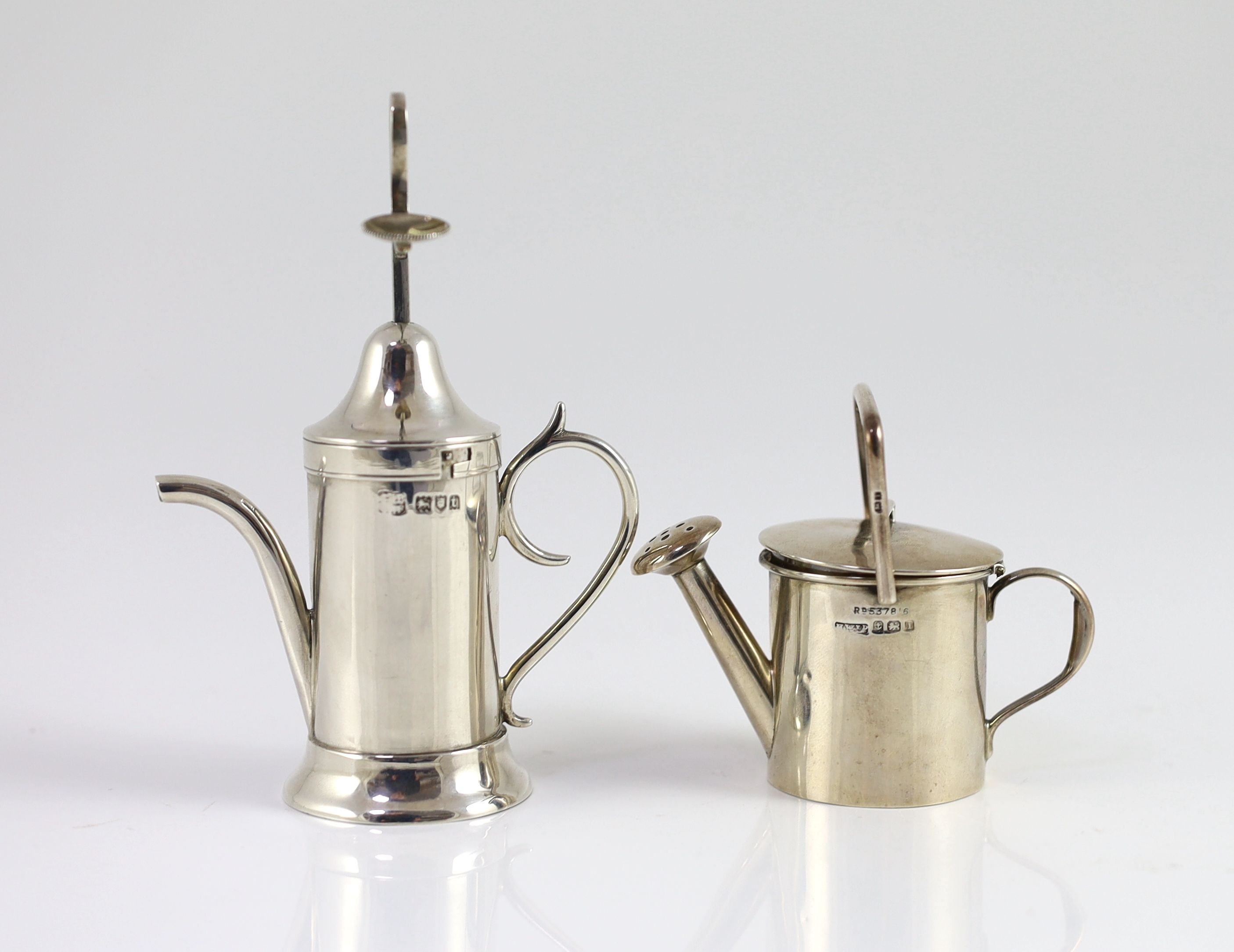 A George V silver novelty atomiser modelled as a pouring vessel, London, 1914, 12.3cm and a novelty silver compact?